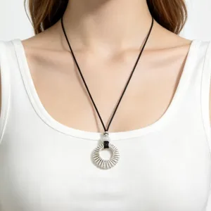 Detailed view of the silver hollow circle pendant necklace worn gracefully on neck.