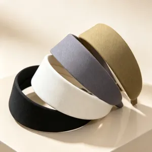 Detailed view of retro fabric wide-brim headbands in black, white, grey, and khaki colors.