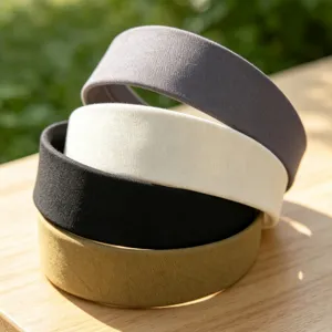 Detail shot of stacked fabric wide headbands in neutral colors, soft texture, daily wear accessory.