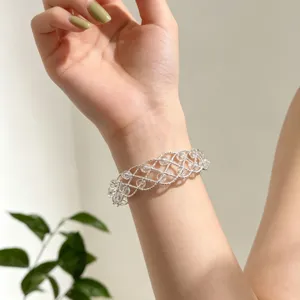Dettaglio bracciale in perle di cristallo intrecciate argento con design elegante e chic.