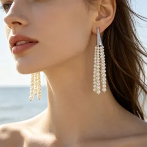 Elegant long pearl tassel earrings featuring a sparkling paved cone stud design for chic look