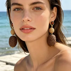 Elegant straw woven drop earrings with amber stone detail, perfect for beach and summer.