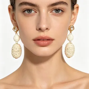 Detailed close-up of ethnic style rhinestone and woven hemp rope earrings, elegant unique design.