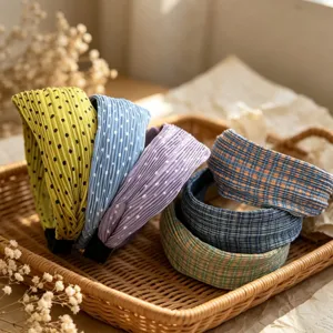 Detailed view of Korean pleated polka dot and plaid wide hairbands, stylish hair accessories.