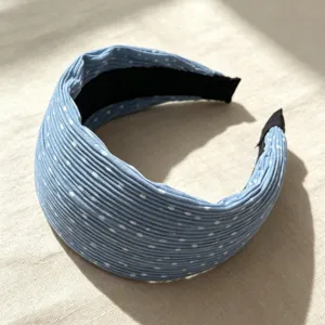 Detailed view of the blue pleated polka dot wide headband showing fine fabric texture