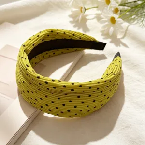 Korean style yellow pleated polka dot wide headband, stylish hair accessory detail view.