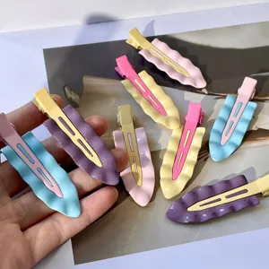 Detailed view of pastel metal wavy hair clips, sweet candy color side hairpins for styling.