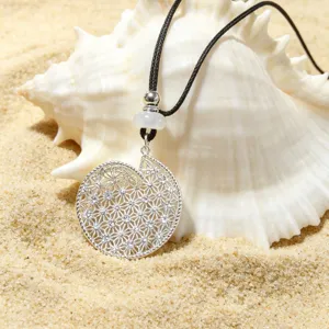 Exquisite silver hollow shell pendant necklace detail on beach background, elegant accessory.
