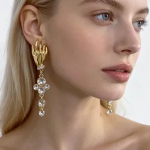 Detailed close-up view of French vintage gold palm design earrings with sparkling crystals.