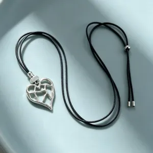 Silver hollow heart pendant necklace with adjustable black cord for women daily fashion jewelry.