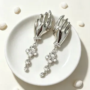 Exquisite silver hand dangle earrings featuring sparkling rhinestones and delicate crystal clover dangles.