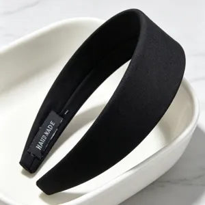 Detailed view of black fabric wide headband, retro high crown hair hoop for daily and makeup.