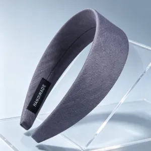 Detail view of a vintage grey fabric wide headband, featuring a soft textured surface design.
