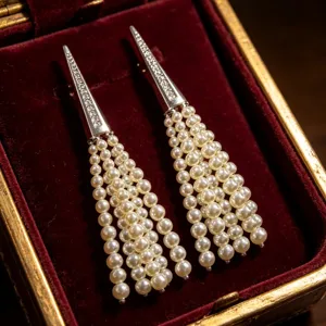 Detail view of elegant long pearl fringe tassel earrings featuring a diamond pavé top.