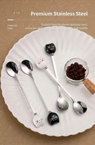 Stainless steel long handle mixing spoon with cute ceramic cat design for coffee and dessert use.