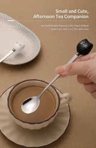 Stainless steel mixing spoon with cute ceramic cat handle, perfect for coffee and dessert.
