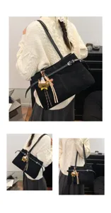 Detail view of stylish black suede women shoulder bag with cute bear charm for winter daily commute.