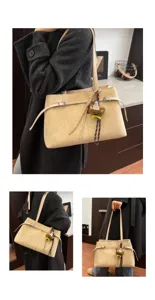 Shoulder bag detail view showing soft suede material, adjustable strap, and cute bear charm.