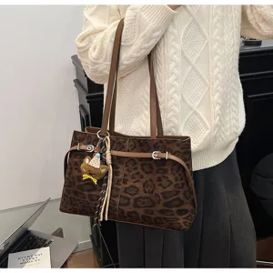 Detailed shot of the brown leopard print tote bag worn by model, showcasing stylish design.