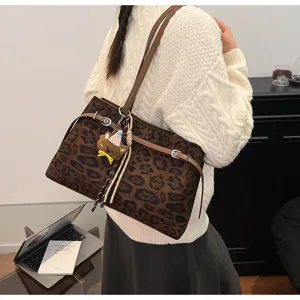 Stylish brown leopard print shoulder tote bag with cute bear pendant for women commuting.