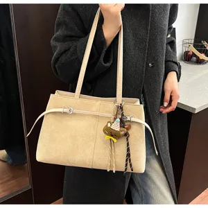 Chic suede shoulder bag for women, featuring belt detail and cute bear charm for daily wear.