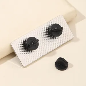 Detailed view of the metal enamel lapel pin back with black rubber clutches securely attached.