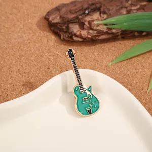Exquisite metal guitar enamel brooch, elegant gold and green fashion badge for outfits.