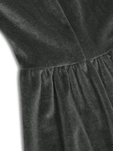 Close-up view of dark grey velvet dress waist pleated detail texture fabric display