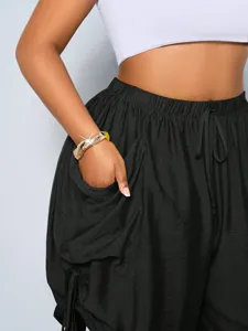 Detail view of women high waist loose harem shorts with large pocket and drawstring.