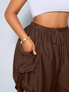 Detail view of women's high-waisted loose harem shorts featuring a drawstring and large pockets.