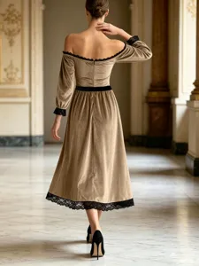 Detail view of elegant off-the-shoulder velvet midi dress with delicate black lace trim for women.