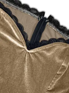 Gold velvet dress detail shot featuring elegant black lace trim and back zipper design.