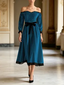 Elegant velvet midi dress detail featuring off-shoulder design and delicate black lace trim.