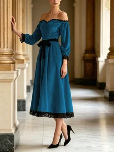 Stunning velvet dress detail showcasing elegant off-shoulder design and delicate black lace trim.