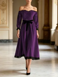Stunning off-shoulder purple velvet midi dress with black lace trim and waist bow detail.