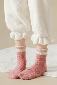 Soft coral fleece fuzzy socks detail, cozy winter warm floor socks with cute pink and white.