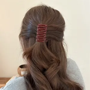 Minimalist chocolate brown interlocking hair claw clip, elegant everyday styling accessory.