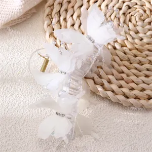 Large white butterfly hair claw clip detail view, elegant sheer fabric shark clip accessory.