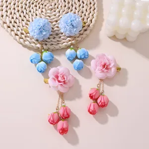Detailed view of handmade vintage velvet flower hair clips with cute hanging buds and secure metal clips.