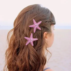 Pink starfish hair clip detail showcasing summer beach style and cute design for women.