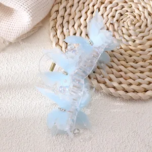 Detail view of a light blue butterfly hair claw clip with mesh wings and faux pearls.