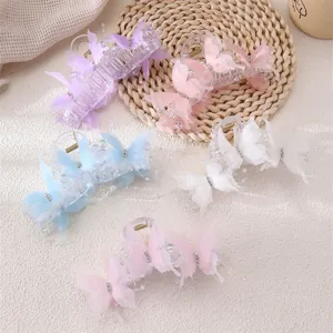 Detailed shot of cute butterfly hair claw clips with sheer mesh design and pearl details.