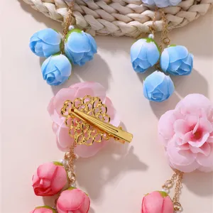 Detail shot of Chinese ancient style fabric flower hair clip with pink and blue rose drops.