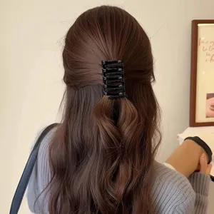 Minimalist black hair claw clip detail shot, elegant cross design for daily styling and chic buns.