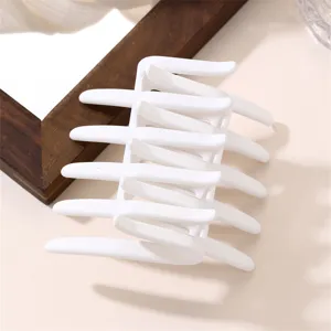 Minimalist white hair claw clip with geometric cross design, elegant styling accessory.