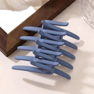 Matte blue hair claw clip with cross teeth design for stylish everyday updo hairstyles.
