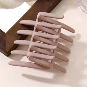 Matte nude pink hair claw clip detail shot, showing the stylish rectangular cross-tooth design.