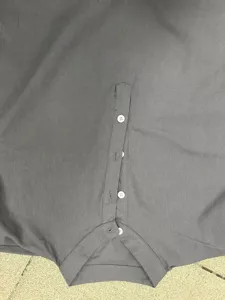 Close-up detail of mens casual short sleeve shirt collar and button placket design.
