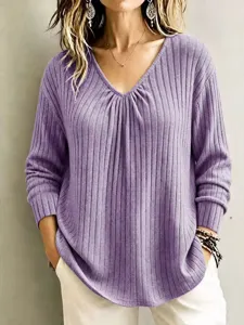 Detailed view of women's ribbed V-neck long sleeve casual knit top in solid color.