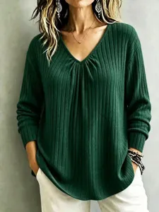 Detail shot of casual green ribbed V-neck long sleeve top showcasing soft knit texture.